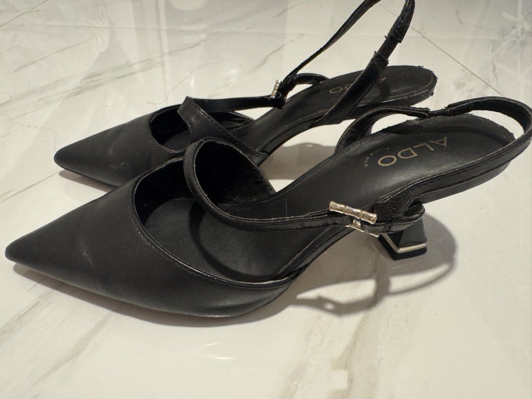 ALDO Black Slingback Pointed Toe Heels with Low Block Heel (Category: Heels) located in Valenzuela. Submitted by tricegonzales (Listing ID 1466595820, Image 2). Description: - Brand: ALDO - Style: Pointed toe heels with slingback strap and buckle detail - Heel: Low block heel for all-day comfort - Comfort: Pillow Walk cushioned insoles - Occasion: Versatile for work or formal events - Condition: Minimal wear on soles and leather upper.