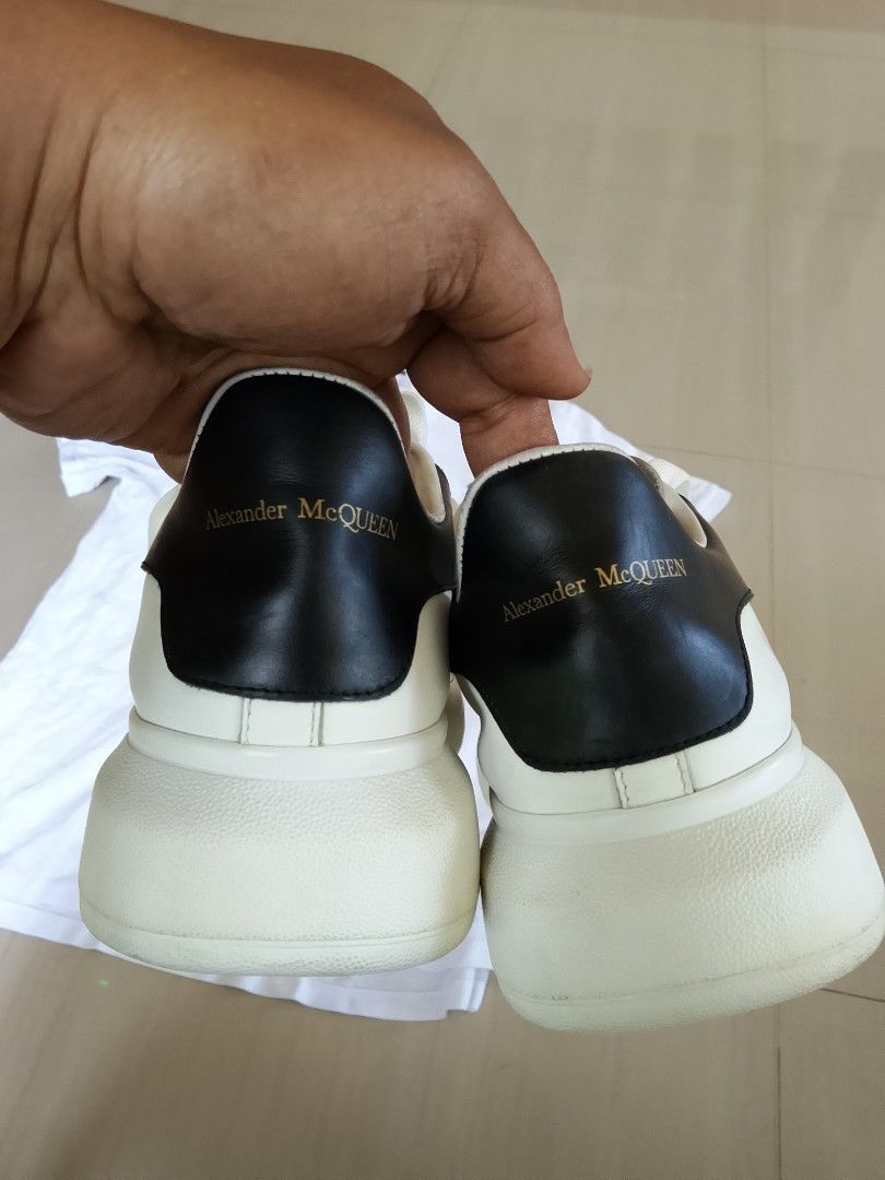 Alexander McQueen Oversized Sneaker White Black Size 41 (Category: Sneakers) located in Manila. Submitted by arjaygoodfind (Listing ID 1466657633, Image 2). Description: - Brand/Model: Alexander McQueen Oversized Sneakers - Colorway: White leather with striking black heel counters - Size: EU 41 (stamped inside the tongue) - Details: Signature gold foil logo stamped on the tongues and back tabs - Soles: Iconic thick white rubber soles - Condition: