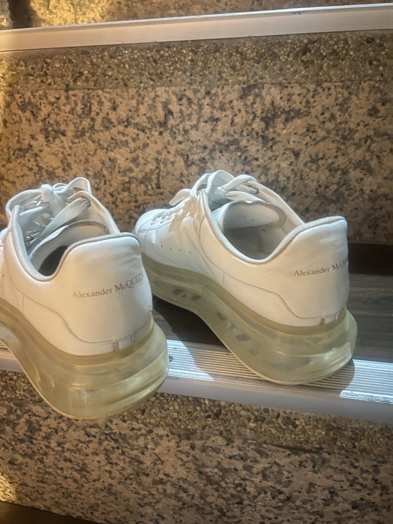 Alexander McQueen Oversized Tread Slick Sneakers White (Category: Sneakers) located in Paranaque City. Submitted by sctmpque (Listing ID 1466733437, Image 1). Description: - Brand: Alexander McQueen - Color: White with clear chunky soles - Material: Premium leather upper with side perforations - Design: Classic low-top, lace-up closure, branded heel counter and tongue - Condition: Worn with visible outsole wear and minor yellowing on the transpar