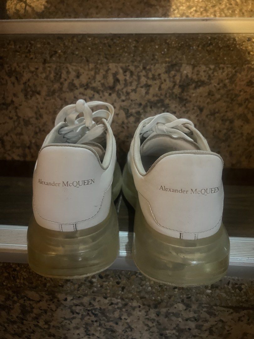 Alexander McQueen Oversized Tread Slick Sneakers White (Category: Sneakers) located in Paranaque City. Submitted by sctmpque (Listing ID 1466733437, Image 2). Description: - Brand: Alexander McQueen - Color: White with clear chunky soles - Material: Premium leather upper with side perforations - Design: Classic low-top, lace-up closure, branded heel counter and tongue - Condition: Worn with visible outsole wear and minor yellowing on the transpar