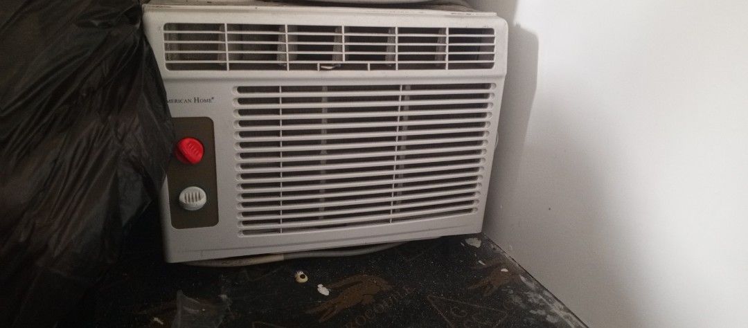 American Home Window Air Conditioner Unit (Category: Air Conditioning and Heating) located in Valenzuela. Submitted by marquilenc35331 (Listing ID 1466566964, Image 1). Description: - Brand: American Home - Type: Window Air Conditioner - Color: White - Controls: Dual manual knobs (Red for power/mode, White for temperature) - Design: Standard horizontal louver grill - Condition: Good working condition with minor dust from storage - Perfect for bud