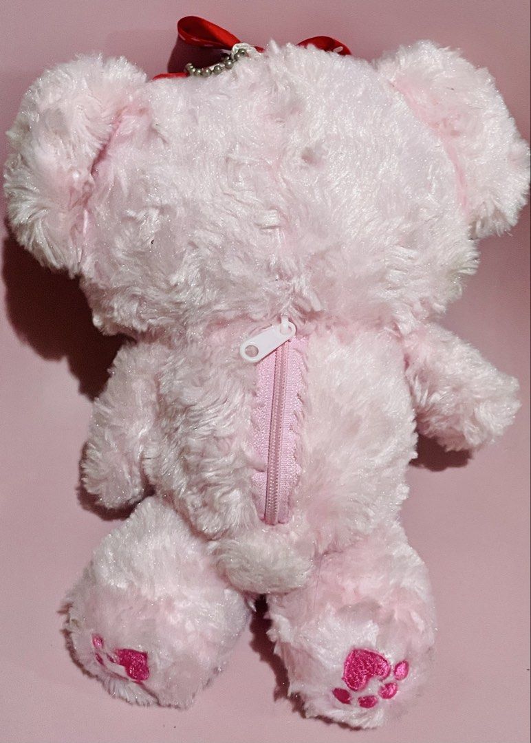 Amuse Classical Pink Bear (Category: Plushies & Soft Toys) located in Pasig City. Submitted by babystarcandykoo (Listing ID 1466693896, Image 2). Description: - Adorable fluffy pink bear plush with soft textured fur - Features a mini zipper storage pouch on the back - Cute pink heart paw prints on the feet and a red ribbon on top - Comes with a silver ball chain to hang easily on bags or keys - Great as a gift, accessory, or cute collectible.