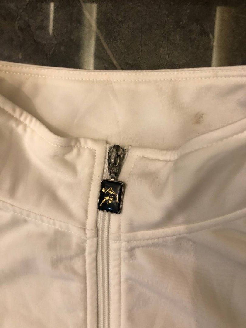 AND1 Vintage Track Jacket White Red Blue Size M (Category: Coats, Jackets and Outerwear) located in Santa Cruz. Submitted by remsonnnc (Listing ID 1466623068, Image 3). Description: - Brand: AND1 - Color: White with red and blue side stripes - Size: Medium (made in Taiwan) - Details: Full zip, custom logo zipper pull, red chest embroidery, and large back logo graphic - Condition: Good pre-loved condition with a small stain on the inner collar - P