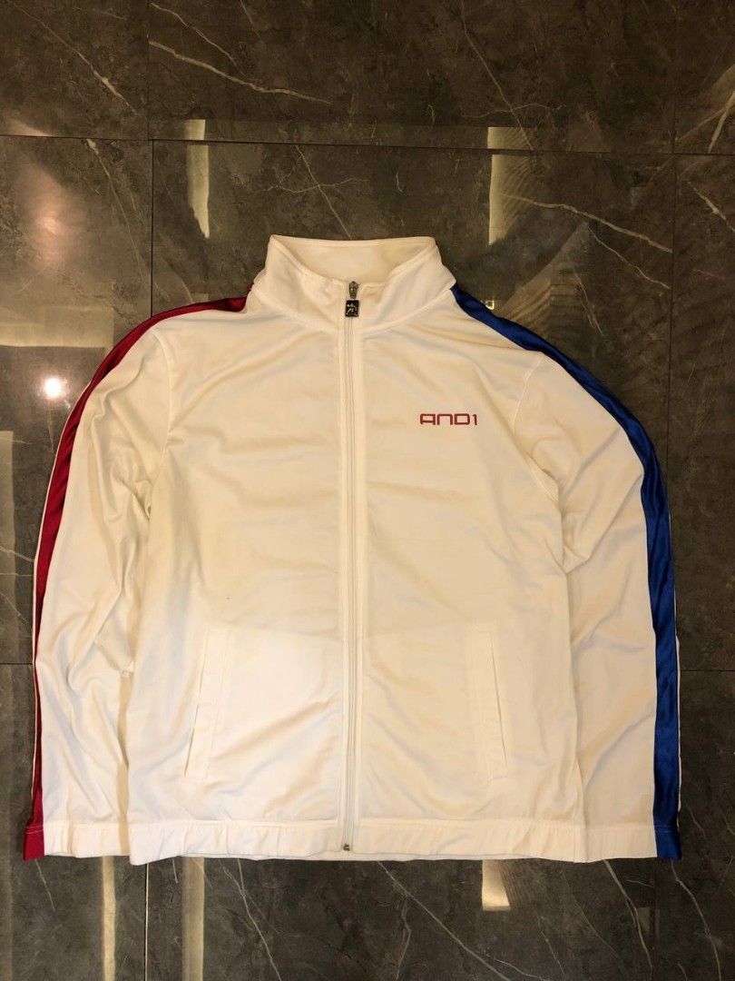 AND1 Vintage Track Jacket White Red Blue Size M (Category: Coats, Jackets and Outerwear) located in Santa Cruz. Submitted by remsonnnc (Listing ID 1466623068, Image 1). Description: - Brand: AND1 - Color: White with red and blue side stripes - Size: Medium (made in Taiwan) - Details: Full zip, custom logo zipper pull, red chest embroidery, and large back logo graphic - Condition: Good pre-loved condition with a small stain on the inner collar - P