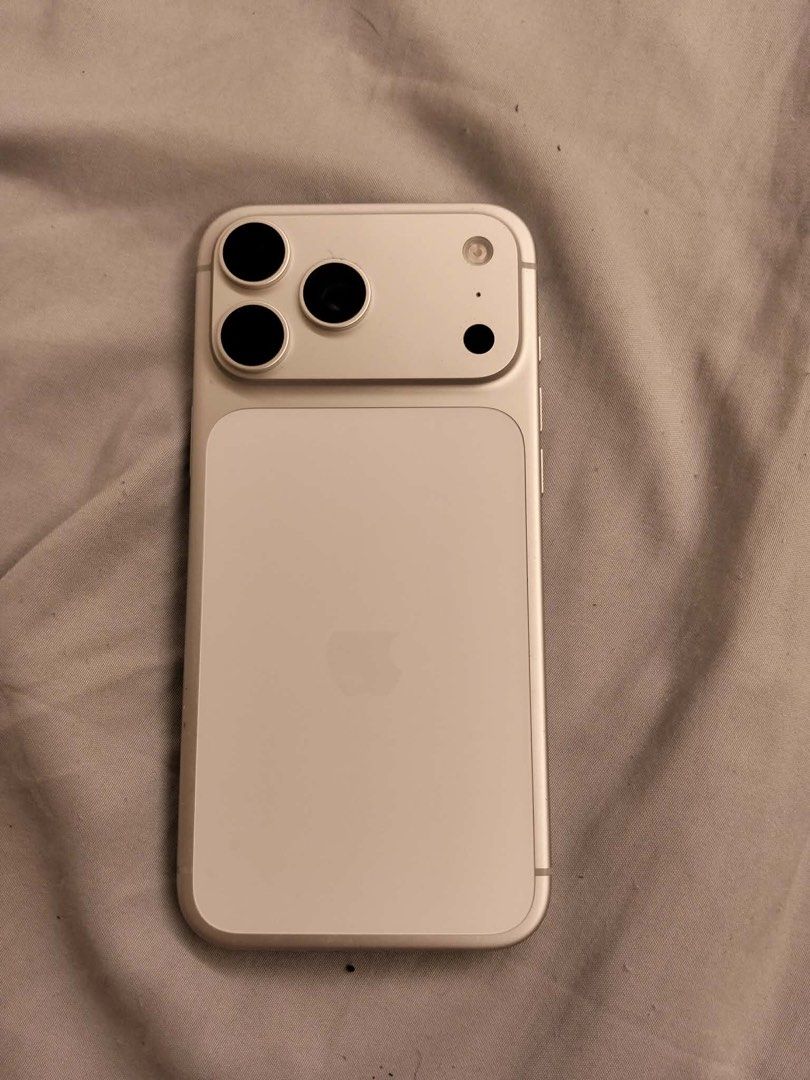 Apple iPhone 256GB Silver (Category: iPhone 17 Series) located in Quezon City. Submitted by quickflower_81f052 (Listing ID 1466566232, Image 2). Description: - Model: Silver with 256GB storage - Battery Health: 99% (212 cycle counts) - Display: Standard Dynamic Island cutout - Camera: Triple rear camera setup - Condition: Clean body, fully functional daily driver - still in warranty - Reason for selling: Upgrading soon Inclusion : Charger and Box