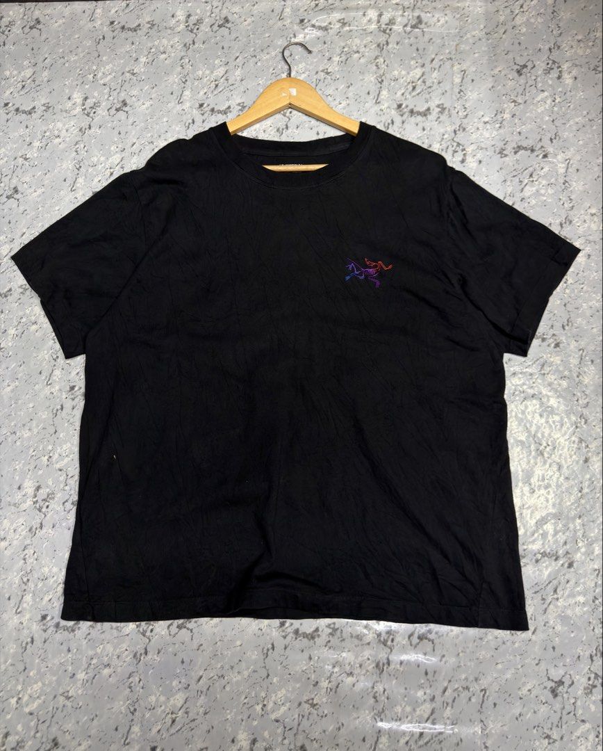 Arcteryx Black T-Shirt with Gradient Logo (Category: Tshirts & Polo Shirts ) located in Manila. Submitted by raven236 (Listing ID 1466722948, Image 1). Description: - Brand: Arc'teryx - Color: Black - Size: Small - Fit: Standard - Material: 100% comfortable cotton - Design: Crew neck with purple-to-red gradient embroidered chest logo - Condition: Excellent, no stains or damage spotted.