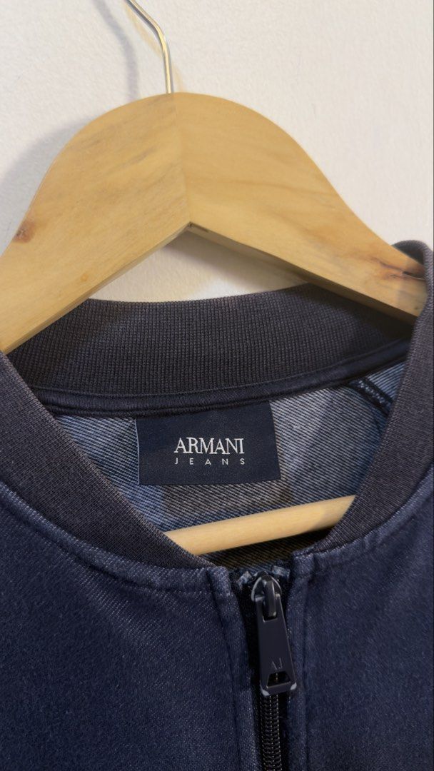 Armani Jeans Bomber Jacket (Category: Coats, Jackets and Outerwear) located in Paranaque City. Submitted by preluxeshop_ph (Listing ID 1466765437, Image 3). Description: Armani Jeans Bomber Jacket -Classic zip-up style -Ribbed collar, cuffs, and hem -Condition: 9.8/10 -Dimes: Length: 24” Width: 20”.
