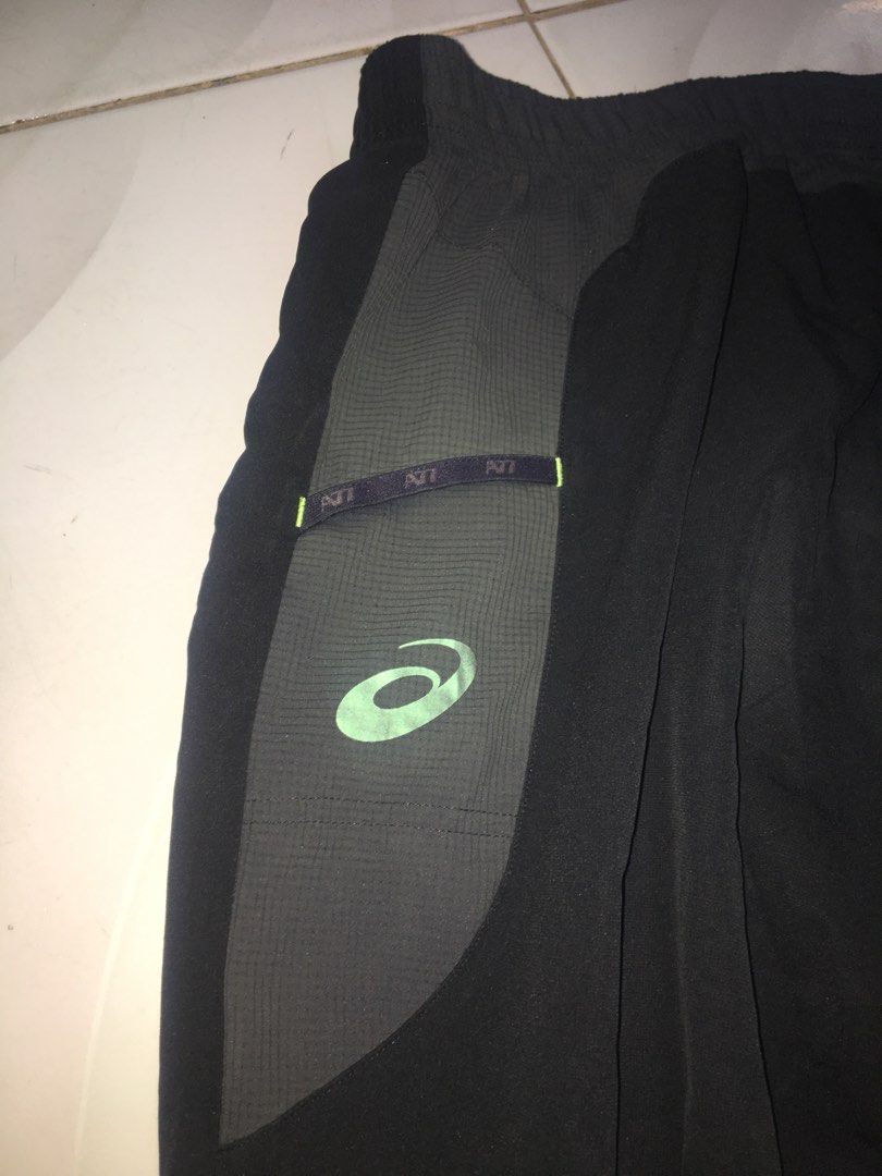 Asics A77 Infinite Performance Track Pants (Category: Joggers) located in Makati City. Submitted by emilyn_019 (Listing ID 1466603313, Image 3). Description: - Brand: Asics A77 - Color: Black with contrast grey panels and green accents - Design: 'Infinite Performance' lettering on the front and A77GA logo on the lower leg - Fit & Features: Elastic waistband with white drawstring cords and adjustable cinch hems - Authenticity: Features the classic
