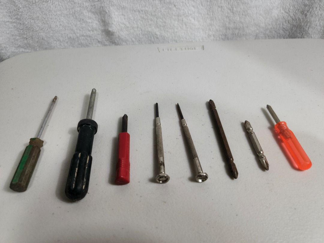 Assorted Hand Screwdrivers and Screwdriver Bits Lot (Category: Construction Tools & Equipment) located in San Leonardo. Submitted by burgossanleonardo.12345 (Listing ID 1466693650, Image 2). Description: - Mixed set featuring standard handles, precision miniature screwdrivers, and loose bits - Includes various sizes and tip types for different needs - Perfect for basic household repairs and DIY projects - Condition: Shows some rust on shafts and 