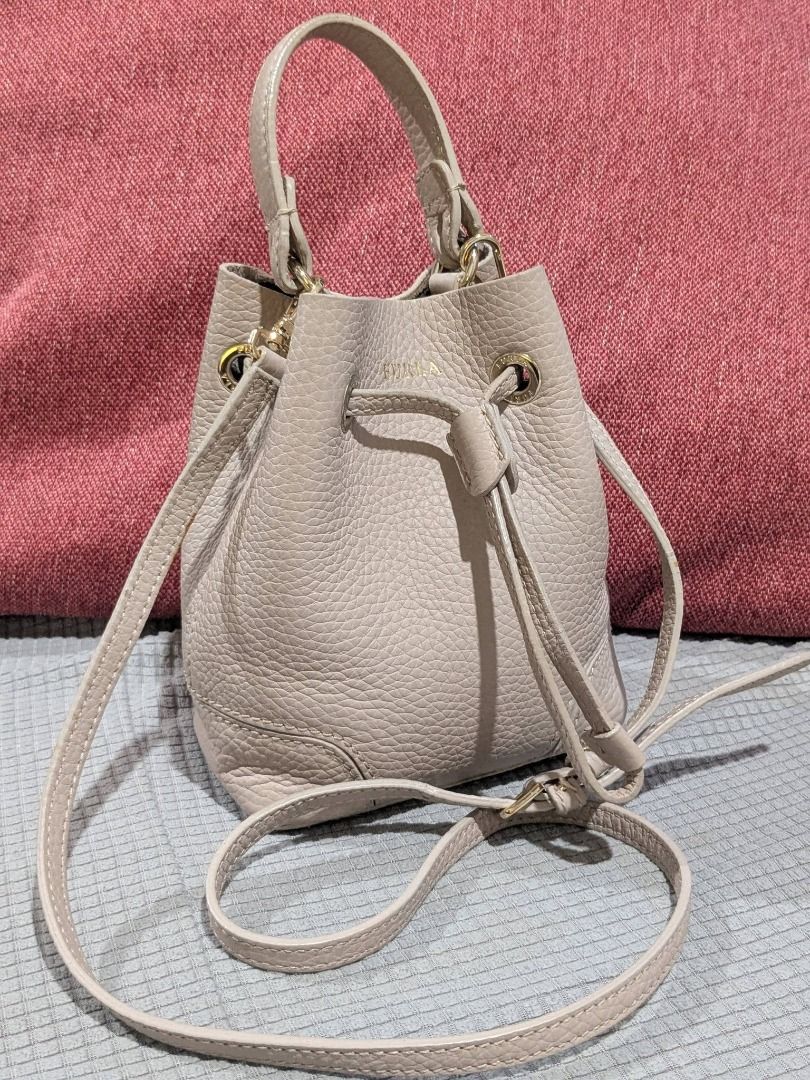 Authentic Furla small bucket sling bag (Category: Luxury Bags & Wallets) located in Tuguegarao City. Submitted by globeeneace (Listing ID 1466569287, Image 2). Description: Guaranteed Original Very good condition -signs of usage ( minimal rubber lining cracks) genuine Leather small size.