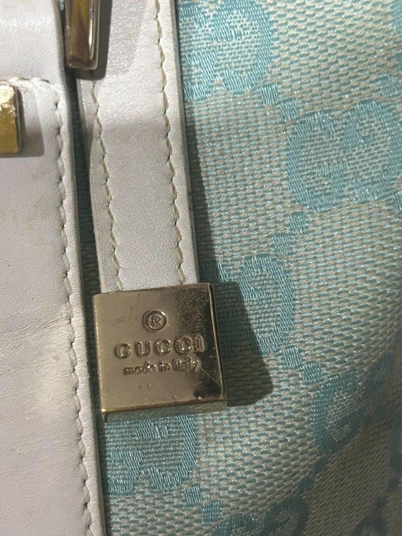 Authentic Gucci Blue GG Canvas Boston Bag (Category: Luxury Bags & Wallets) located in Marikina City. Submitted by aussiemaan (Listing ID 1466626868, Image 2). Description: - Authentic Gucci Boston bag in light blue and white GG monogram canvas - White leather handles, trim, and gold-tone hardware details - Secure zip top closure with interior serial number tag - Condition: Shows visible scuffing and wear on the white leather corners and handles 