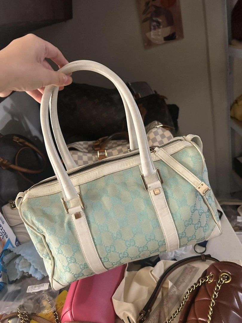 Authentic Gucci Blue GG Canvas Boston Bag (Category: Luxury Bags & Wallets) located in Marikina City. Submitted by aussiemaan (Listing ID 1466626868, Image 1). Description: - Authentic Gucci Boston bag in light blue and white GG monogram canvas - White leather handles, trim, and gold-tone hardware details - Secure zip top closure with interior serial number tag - Condition: Shows visible scuffing and wear on the white leather corners and handles 