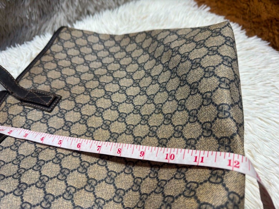 Authentic Gucci GG Supreme Monogram Tote Bag (Category: Tote Bags) located in Marikina City. Submitted by aussiemaan (Listing ID 1466628847, Image 3). Description: - Authentic Gucci tote bag with classic GG monogram pattern - Dark brown leather handles, trim, and interior serial tag (211120 213048) - Clean light beige canvas interior lining - Dimensions: approx. 17 inches across x 12 inches high - Roomy and stylish everyday shoulder bag - Meetup 