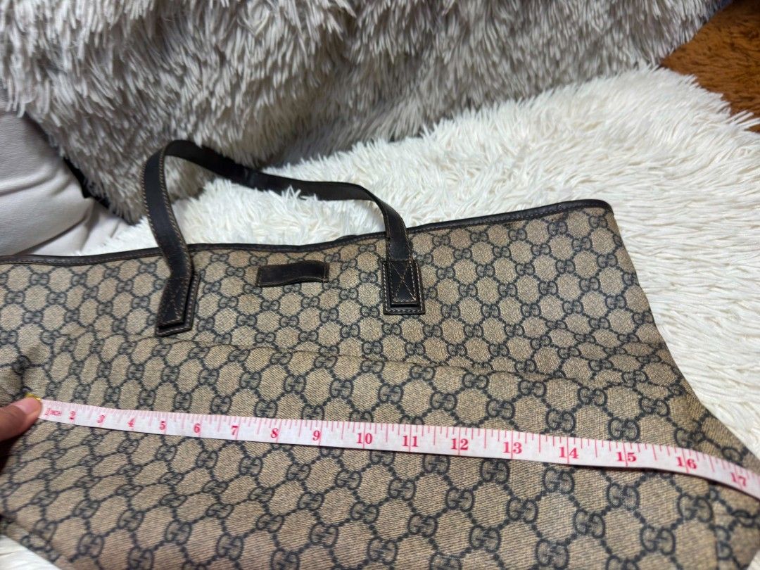 Authentic Gucci GG Supreme Monogram Tote Bag (Category: Tote Bags) located in Marikina City. Submitted by aussiemaan (Listing ID 1466628847, Image 2). Description: - Authentic Gucci tote bag with classic GG monogram pattern - Dark brown leather handles, trim, and interior serial tag (211120 213048) - Clean light beige canvas interior lining - Dimensions: approx. 17 inches across x 12 inches high - Roomy and stylish everyday shoulder bag - Meetup 