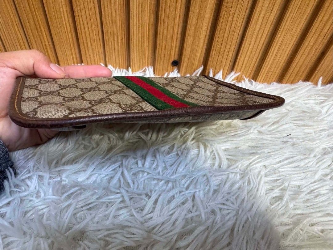 Authentic Gucci Monogram Clutch Bag with Web Stripe (Category: Luxury Bags & Wallets) located in Marikina City. Submitted by aussiemaan (Listing ID 1466629391, Image 2). Description: - Authentic vintage Gucci monogram canvas clutch - Features signature green and red web stripe and brown leather trim - Elegant gold-toned button closure on the front flap - Finished with durable brown leather corner patches - Slim profile design, perfect for daily u