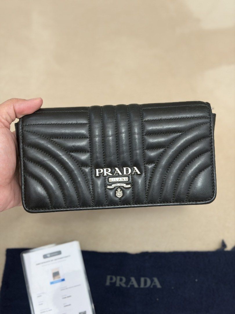 Authentic Prada Diagramme Wallet on Chain (Category: Cross-body Bags) located in Manila. Submitted by maria_2326 (Listing ID 1465994386, Image 2). Description: Prada Diagramme Wallet on Chain 💯% Authentic | fits pro max W/dust bag, chain sling, prada card, certificate of authenticity and bag organizer No lowballing! Location: Manila/QC.