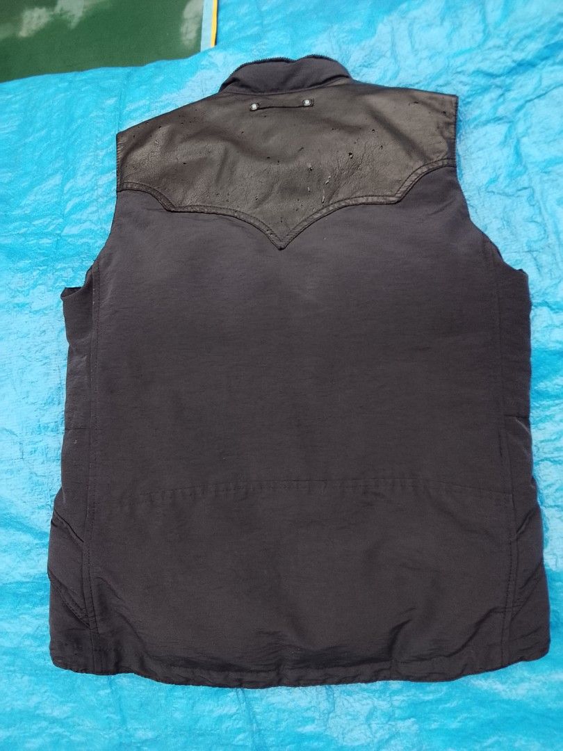 Authentic Takeo Kikuchi down vest (Puffer vest) (Category: Vests) located in Manila. Submitted by newage.vintage (Listing ID 1466661860, Image 2). Description: - brand: Takeo Kikuchi - materials: 90% down, 10% feather, - corduroy collar, genuine leather shoulder yoke - hardware: Ykk zipper - Style: outdoor / workwear down vest - excellent condition -Dimes 28X22 - negotiable price - 2 pockets on front, and 2 pockets inside.