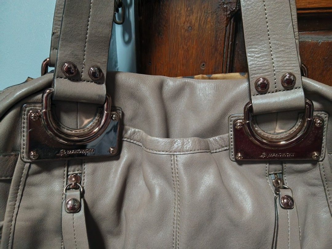 B. Makowsky Taupe Leather Shoulder Bag (Category: Shoulder Bags) located in Quezon City. Submitted by matcarla (Listing ID 1466731124, Image 2). Description: - Brand: B. Makowsky - Material: Genuine taupe leather with chic rose gold tone hardware - Straps: Double shoulder straps with stud details and decorative metal plate accents - Exterior: Front zip pockets for easy access to essentials - Interior: Fun leopard print fabric lining with a zipper