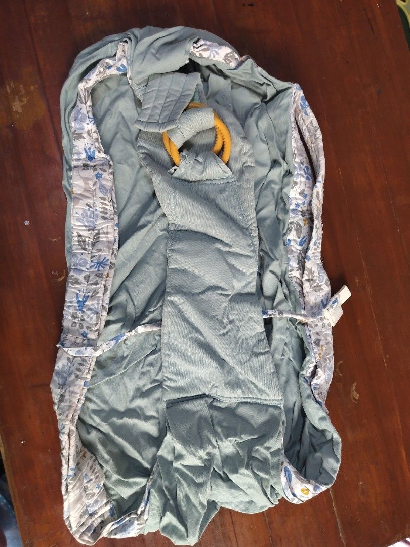 Baby ring sling carrier with floral pattern (Category: Carriers & Slings) located in Manila. Submitted by kwin15 (Listing ID 1466572571, Image 1). Description: - Color: Green with blue and white floral borders - Hardware: Yellow plastic adjustment ring - Material: Breathable fabric with soft padding along the edges for extra comfort - Adjustable length for a customized, secure fit - Lightweight and easy to fold for your diaper bag - Brand new and