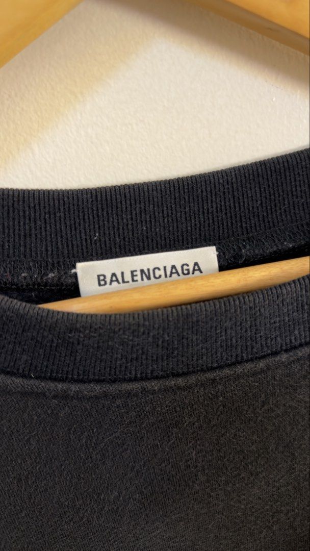 Balenciaga Back Patch Logo Sweatshirt Black Size L (Category: Coats, Jackets and Outerwear) located in Paranaque City. Submitted by preluxeshop_ph (Listing ID 1466769592, Image 3). Description: Balenciaga Back Patch Logo Sweatshirt Black Size L - Color: Washed black - Size: L (Tag and care label attached) - Unique distressed denim patch across upper back with blue embroidered branding - Ribbed crewneck, cuffs, and hem - Relaxed, straight-on-body 