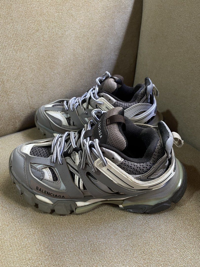 Balenciaga Track (Category: Sneakers) located in Bayugan. Submitted by reymarcastro56 (Listing ID 1466618458, Image 1). Description: - Brand: Balenciaga - Model: Track Sneakers - Colorway: Grey, White, and Black - Size: EU 36 (embossed on toe) - Design: Chunky multi-panel build with mesh and nylon overlays - Details: Balenciaga branding on side and tongue, track logo on back pull tab - Laces: Original grey and white woven laces - Condition: Rubbe