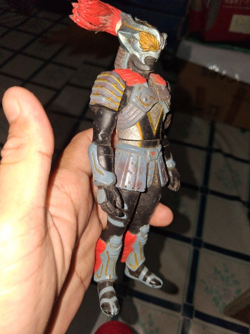 Bandai 2006 Samurai Action Figure (Category: Figurines & Statues) located in Manila. Submitted by marcas022798212 (Listing ID 1466698434, Image 3). Description: Bandai action figure from 2006. Detailed samurai armor design with black, grey, and red elements. Stands about tall. Stamped on the bottom of the foot with Bandai 2006 and China 41712. Dusty from storage, needs cleaning. Good piece for collectors..