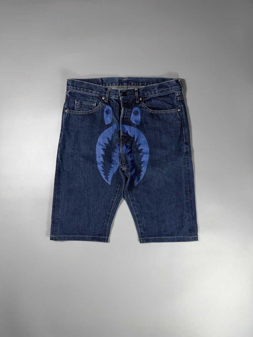 Bape Shark WGM Denim Short (Category: Shorts) located in Manila. Submitted by whowearsstreetwear (Listing ID 1466749974, Image 1). Description: Bape Shark WGM Logo Denim Jorts (Authentic) - (measurements in inches) W - 34 L - 24 Condition: Very Good Flaw/s: hairlines + shipping fee Location: Manila (Near UST).