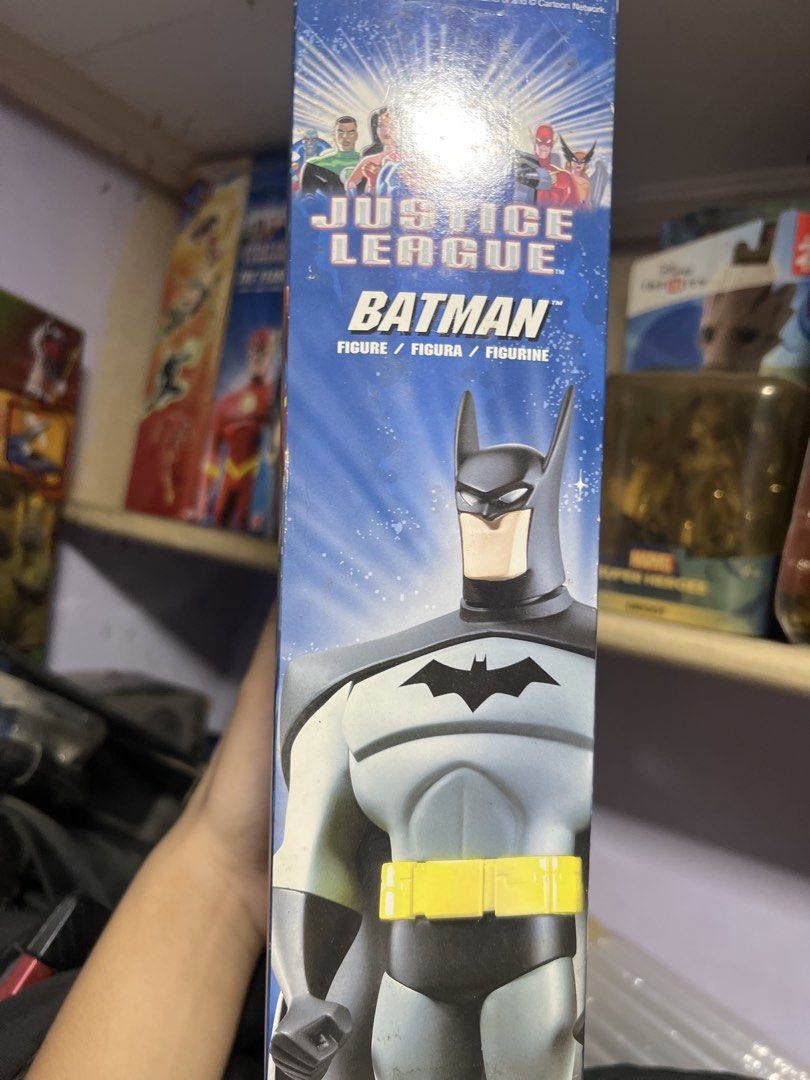 Batman — Mattel Justice League 10” Action Figure (Category: Figurines & Statues) located in Quezon City. Submitted by thegroovearchive (Listing ID 1466679068, Image 3). Description: - Character: Mattel Justice League Batman Action Figure - Size: Stands 10 inches (~25 cm) tall - Design: Classic grey suit with black cowl, cape, and yellow utility belt - Condition: Brand new, unopened packaging (shows minor shelf wear) - Collector's Note: Back of th