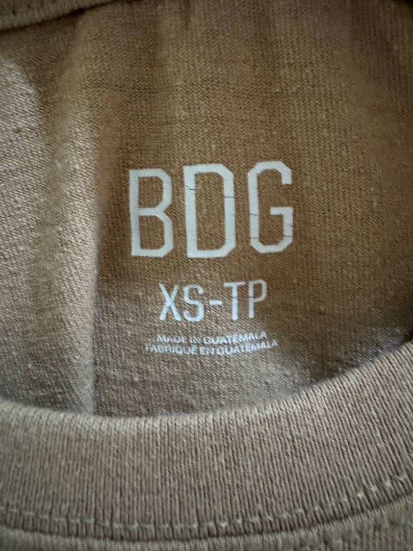 BDG Brown Ribbed Crop Top XS (Category: Sleeveless) located in Taguig. Submitted by anxmz (Listing ID 1466674835, Image 2). Description: - Brand: BDG - Size: XS - Color: Brown (Neutral earth tone) - Neckline: Classic crew neck - Sleeves: Short sleeves - Material: Soft, comfortable cotton blend - Fit: Everyday cropped fit - Styling: Easy to pair with high-waisted denim or skirts; great for layering.