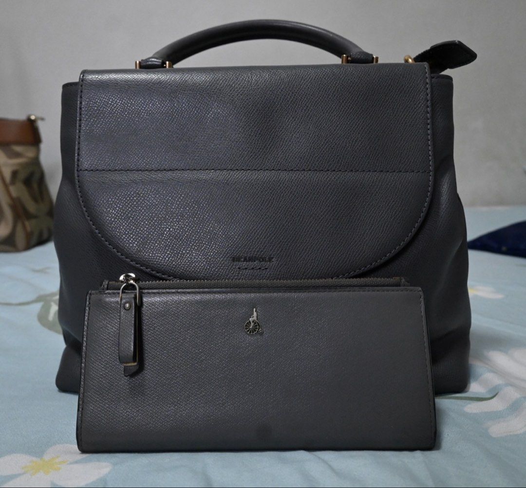 Beanpole Grey Backpack and Matching Wallet Set (Category: Cross-body Bags) located in Quezon City. Submitted by loerna21 (Listing ID 1466732048, Image 1). Description: - Brand: Beanpole - Color/Material: Dark grey textured leather - Set includes: Structured bag (with top handle and front flap) and slim zip-around wallet - Details: Features signature bicycle logo on wallet - Condition: Clean exterior and hardware on both pieces Please manage your 