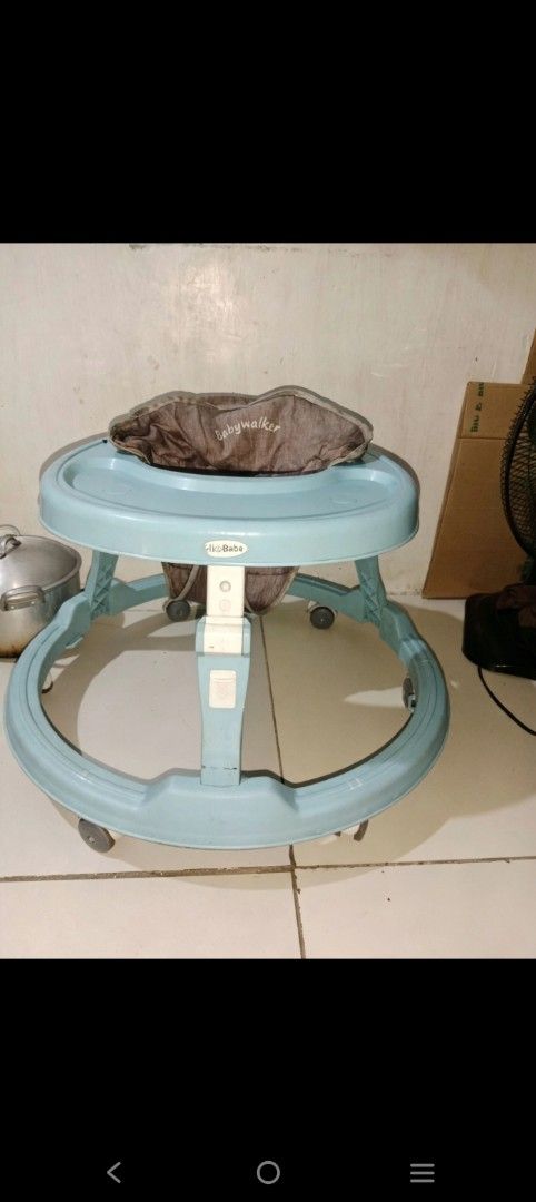 Bebabe Round Baby Walker Light Blue (Category: Infant Playtime) located in Manila. Submitted by caezxc (Listing ID 1466770482, Image 1). Description: - Brand: Bebabe - Color: Light blue frame with brown patterned seat pad - Features: Adjustable center height with locking clips, surrounding tray area, and rolling wheels - Material: Sturdy plastic construction - Condition: Used with visible signs of wear on fabric and frame, but 100% functional and