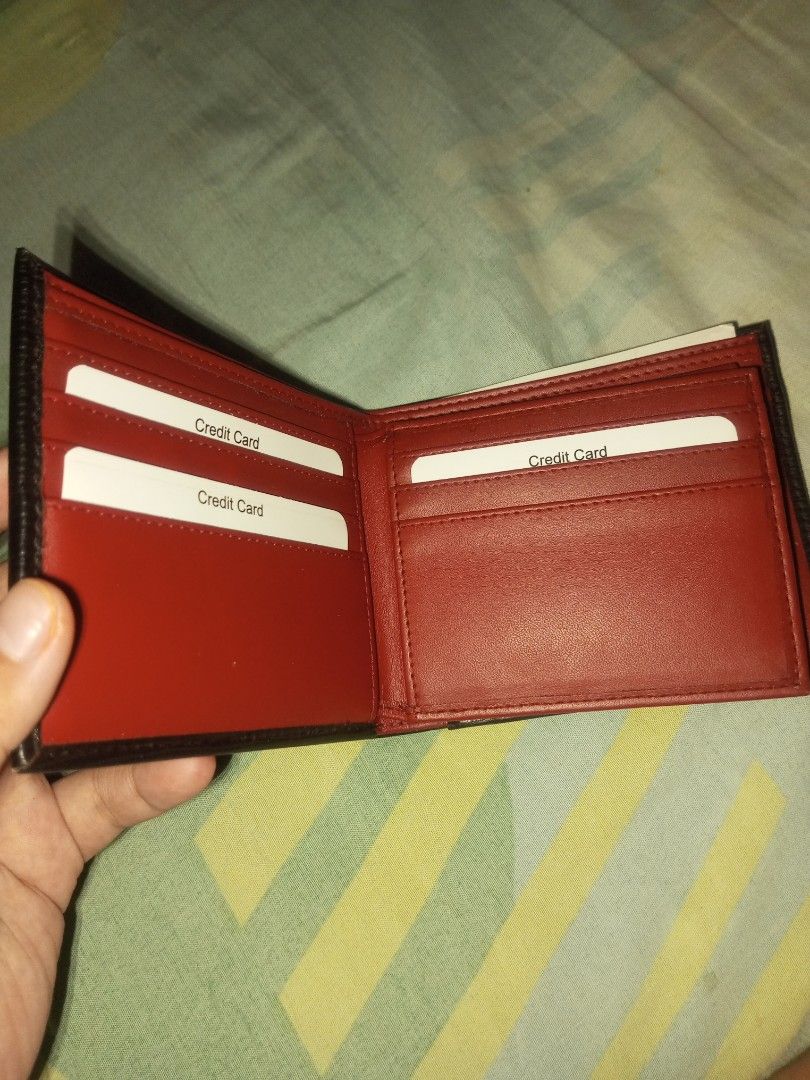 Black and Red Bi-fold Leather Wallet (Category: Wallets & Card Holders) located in Manila. Submitted by preloved119 (Listing ID 1466592339, Image 2). Description: - Style: Minimalist bi-fold wallet - Exterior: Premium black textured leather - Interior: Eye-catching bright red lining - Storage: Multiple card slots on both sides and a clean top bill compartment - Design: Slim profile, pocket-friendly - Condition: Brand new - Shipping: Fast shipping