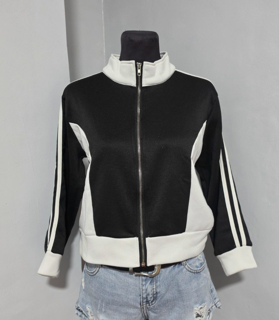 Black and White Track Jacket Zip Up (Category: Coats, Jackets and Outerwear) located in Paranaque City. Submitted by franinnashop (Listing ID 1466640643, Image 3). Description: DECLUTTER SMALL PARANAQUE CITY - Color: Black and white color-block design - Closure: Full zip front with stand-up collar - Details: Double stripes down both sleeves - Fit: Ribbed hem and cuffs for a snug feel - Material: Soft athletic fabric, great for daily wear or worko