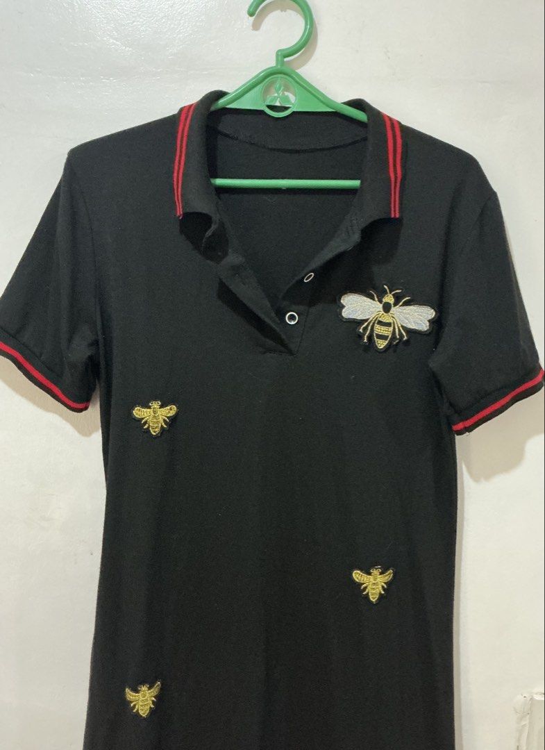 Black Bee Embroidered Polo Dress (Category: Dresses) located in San Pedro. Submitted by itsannabg (Listing ID 1466611577, Image 1). Description: - Color: Black with red stripe accents on the collar and cuffs - Design: Structured collar, 2-button placket, short sleeves - Style: Casual and comfy Can fit S to M.