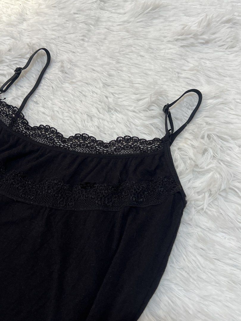 Black camisole with lace trim adjustable straps (Category: Sleeveless) located in Tuguegarao City. Submitted by love_clothies (Listing ID 1466570433, Image 3). Description: - Color: Black - Material: Soft cotton-blend fabric - Details: Delicate lace trim on neckline and upper chest, adjustable spaghetti straps with black hardware - Fit: Fitted silhouette - Condition: Good, ready to wear - Note: Measurements available upon request - Can fit to Sma