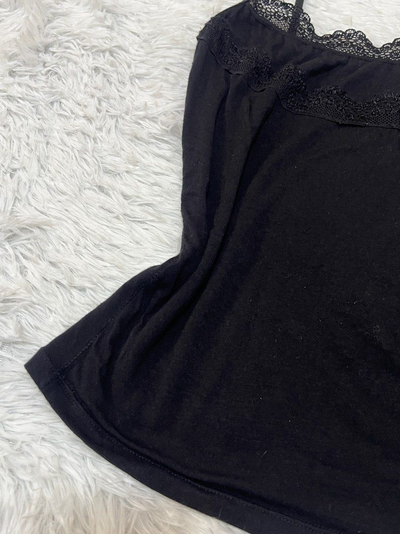 Black camisole with lace trim adjustable straps (Category: Sleeveless) located in Tuguegarao City. Submitted by love_clothies (Listing ID 1466570433, Image 2). Description: - Color: Black - Material: Soft cotton-blend fabric - Details: Delicate lace trim on neckline and upper chest, adjustable spaghetti straps with black hardware - Fit: Fitted silhouette - Condition: Good, ready to wear - Note: Measurements available upon request - Can fit to Sma