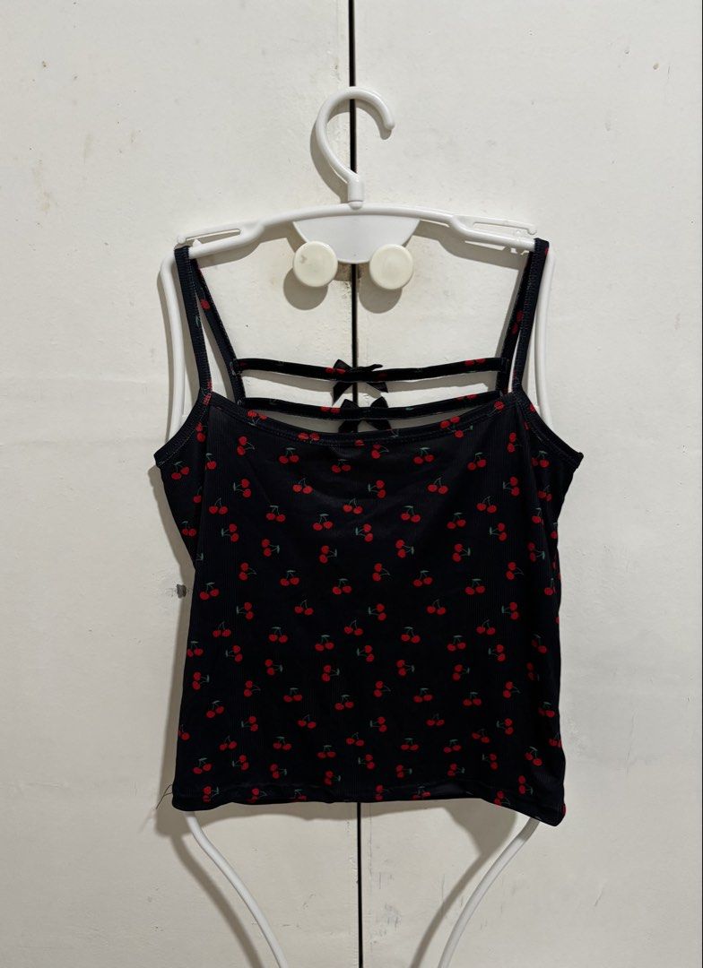 Black Cherry Print Camisole Padded Tank Top (Category: Sleeveless) located in Manila. Submitted by dianafayesimbre (Listing ID 1466771075, Image 2). Description: - Design: Black crop top with all-over red cherry print - Details: Double straps with horizontal accents and cute black ribbon bows on the upper back - Material: Comfortable textured ribbed fabric - Fit: Fitted style with a trendy cropped length - Styling: Easy to pair with high-waisted 