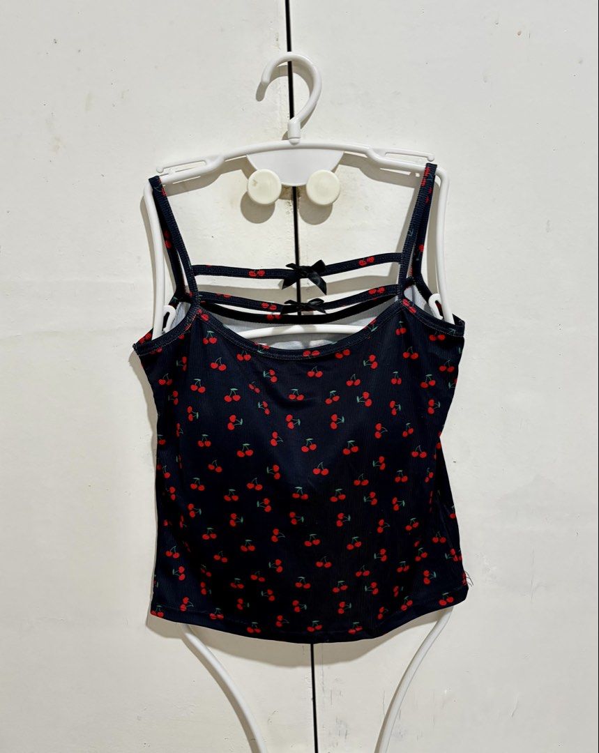 Black Cherry Print Camisole Padded Tank Top (Category: Sleeveless) located in Manila. Submitted by dianafayesimbre (Listing ID 1466771075, Image 1). Description: - Design: Black crop top with all-over red cherry print - Details: Double straps with horizontal accents and cute black ribbon bows on the upper back - Material: Comfortable textured ribbed fabric - Fit: Fitted style with a trendy cropped length - Styling: Easy to pair with high-waisted 