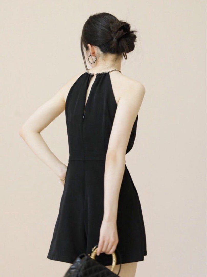 Black Halter Neck Chain Romper Playsuit (Category: Rompers) located in Manila. Submitted by decluterthings888 (Listing ID 1466588960, Image 2). Description: - Color: Black - Style: Sleeveless halter romper with gold-tone chain strap - Fit: Fitted waist with relaxed shorts - Closure: Back zipper with a small keyhole cutout - Fabric: Soft and comfortable - Condition: Clean, worn only once - Occasion: Great for night outs and parties.