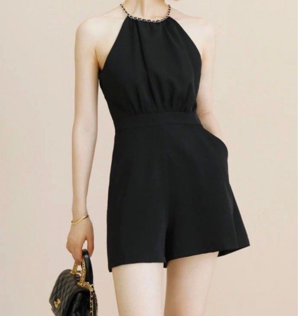 Black Halter Neck Chain Romper Playsuit (Category: Rompers) located in Manila. Submitted by decluterthings888 (Listing ID 1466588960, Image 1). Description: - Color: Black - Style: Sleeveless halter romper with gold-tone chain strap - Fit: Fitted waist with relaxed shorts - Closure: Back zipper with a small keyhole cutout - Fabric: Soft and comfortable - Condition: Clean, worn only once - Occasion: Great for night outs and parties.