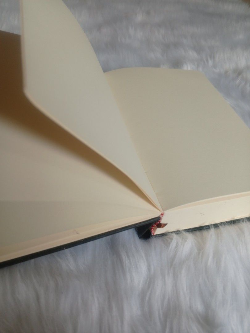 Black Hardcover Notebook Blank Pages Ribbon Bookmark (Category: Stationery & School Supplies) located in Tuguegarao City. Submitted by four-zero-four (Listing ID 1466588687, Image 2). Description: Color: Solid black hardcover Pages: Plain, cream-colored blank pages Features: Built-in ribbon bookmark and sturdy binding Style: Classic minimalist design Best for: Daily journaling, sketching, and note-taking (has minor flaws in-front of the cover).