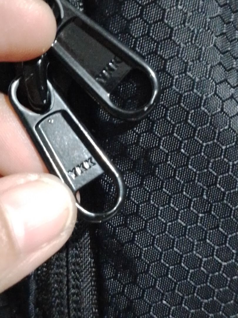 ultralight packable small backpack (Category: Backpacks) located in Imus. Submitted by bestfinds_yeth0724 (Listing ID 1466737484, Image 3). Description: - Color: Sleek black with a unique honeycomb exterior texture - Durability: Equipped with heavy-duty YKK zippers on main and side compartments - Storage: Convenient mesh side pockets for water bottles and small essentials - Comfort: Features padded shoulder straps and a sturdy top grab handle - C
