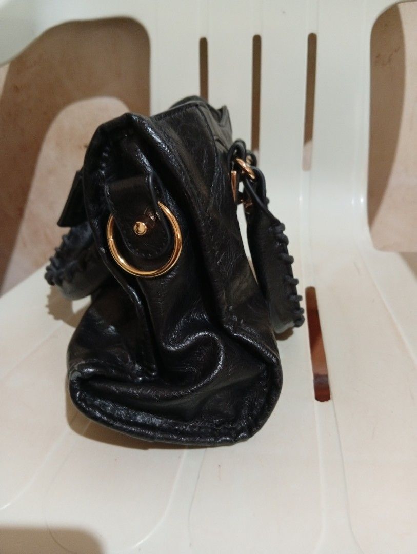 Black Leather Motorcycle Handbag with Gold Hardware (Category: Luxury Bags & Wallets) located in Cebu City. Submitted by champagnescloset (Listing ID 1466772237, Image 2). Description: Black leather handbag with a distinctive crinkled texture. Gold-tone hardware throughout, including studs, buckles, and zipper accents. Whipstitched twin handles on top, plus a front zip pocket and buckle detailing on the bottom corners. Zip closure across the top.
