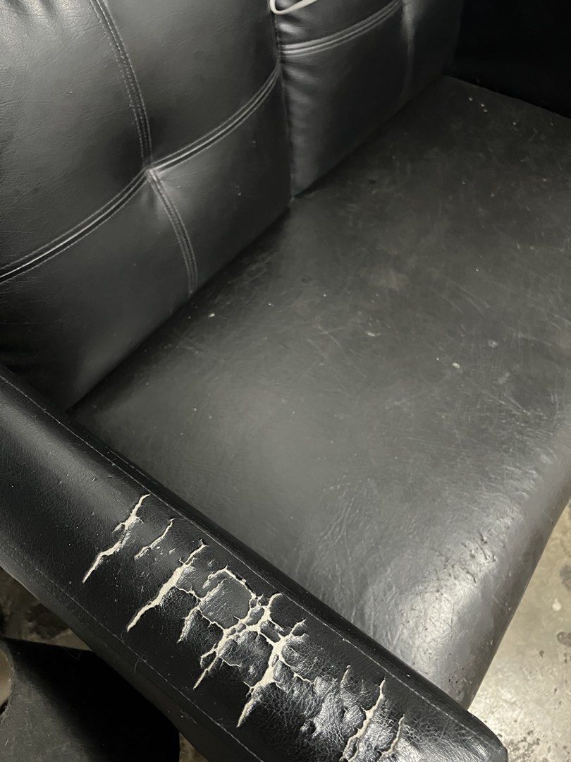 Black leatherette 2-seater sofa (Category: Sofas) located in Manila. Submitted by bosetph (Listing ID 1466689942, Image 2). Description: - Type: Black faux leather 2-seater couch - Ideal for: Small apartments, condo units, or office receiving areas - Condition: Solid structure with plush, comfortable cushions - Flaws: Noticeable cracks and peeling on the left armrest; minor surface scratches on the seat from regular use - Tip: Looks great and fun