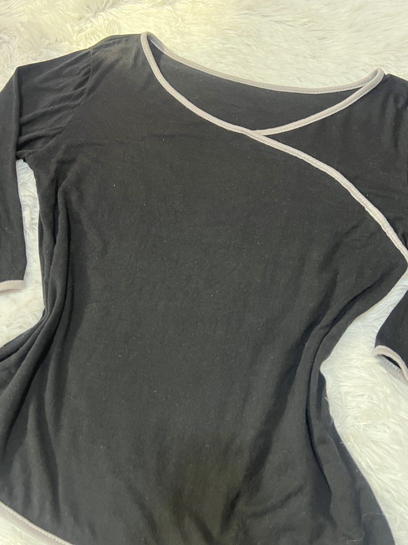 Black Long Sleeve Top with Grey Trim Wrap Design (Category: Longsleeves) located in Tuguegarao City. Submitted by love_clothies (Listing ID 1466572883, Image 3). Description: - Color & Style: Black top with stylish grey piping trim and a wrap-style diagonal front - Size: Small to Medium - Neckline: Open scoop neckline - Sleeves: Three-quarter length sleeves - Fit & Fabric: Fitted cut through the waist made from soft, lightweight, and stretchable 