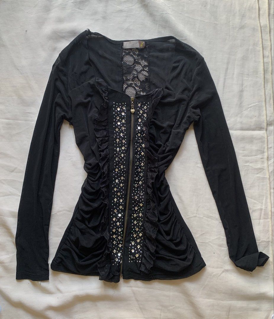 Black mesh top with rhinestones and ruffles (Category: Sleeveless) located in Sarangani. Submitted by solune_clo (Listing ID 1466699761, Image 1). Description: - Color: Black - Material: Sheer mesh, very stretchy - Design details: Vertical rhinestone front panel with ruffle trim - Fit: Ruched sides for a fitted, flattering silhouette - Back details: Lace panel inserts on shoulders - Closure: Cute heart-shaped front zipper pull - Condition: Brand 