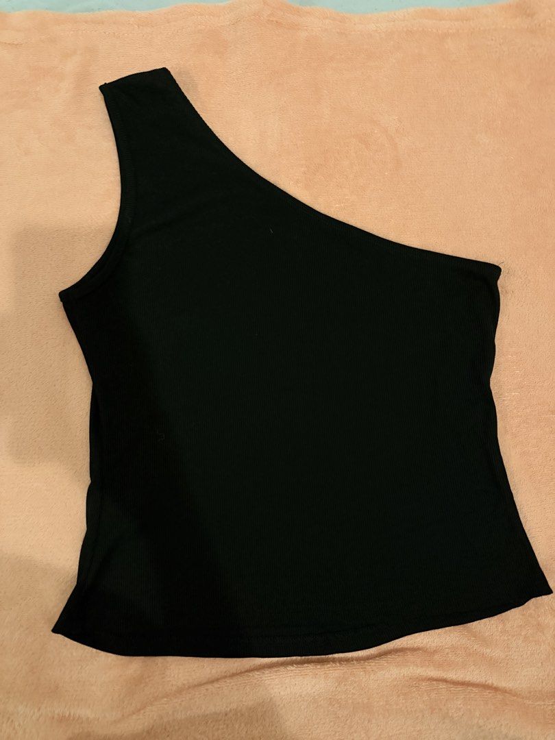Black One-Shoulder Ribbed Tank Top (Category: Sleeveless) located in Pasig City. Submitted by shop.gelss (Listing ID 1466769883, Image 1). Description: - Color: Black - Style: Asymmetric one-shoulder cut - Fabric: Stretchy, comfortable ribbed knit - Versatile: Easy to pair with jeans or skirts for casual days - Condition: Clean and well-maintained.