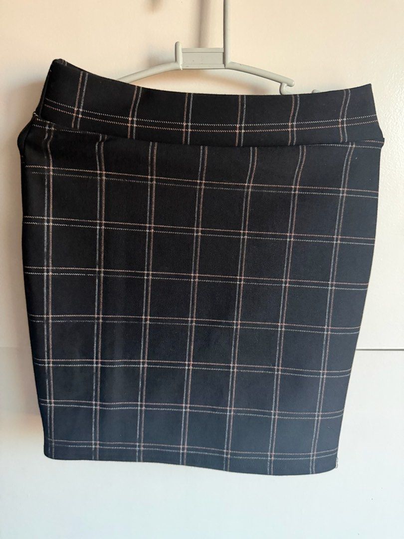 Black Plaid Pencil Skirt Grid Pattern Checkered (Category: Skirts) located in Quezon City. Submitted by bubspreloved (Listing ID 1466722419, Image 2). Description: - Style: High-waisted pencil skirt with a thick waistband - Pattern: Black with a white and pink grid check design - Length: Hits around knee length - Material: Stretchy, super comfortable fabric - Versatility: Clean cut, perfect to pair with plain tops for work or casual days.