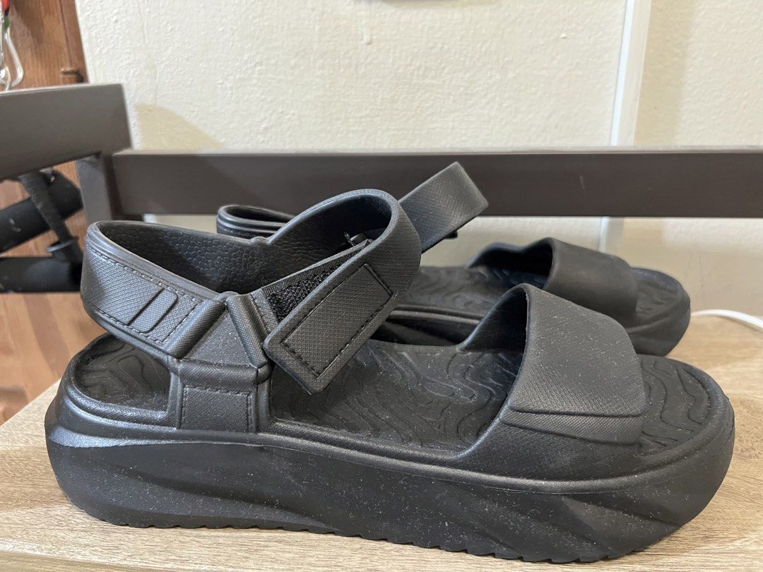 Black Platform Sandals (Category: Flats & Sandals) located in Manila. Submitted by 2s2knpt9nw34311 (Listing ID 1466657966, Image 3). Description: - Color: Black - Style: Minimalist open-toe platform sandals - Features: Chunky soles, adjustable velcro straps, and wavy textured footbed for grip - Material: Lightweight foam construction for easy slip-on wear - Ideal for: Casual walking and daily use.
