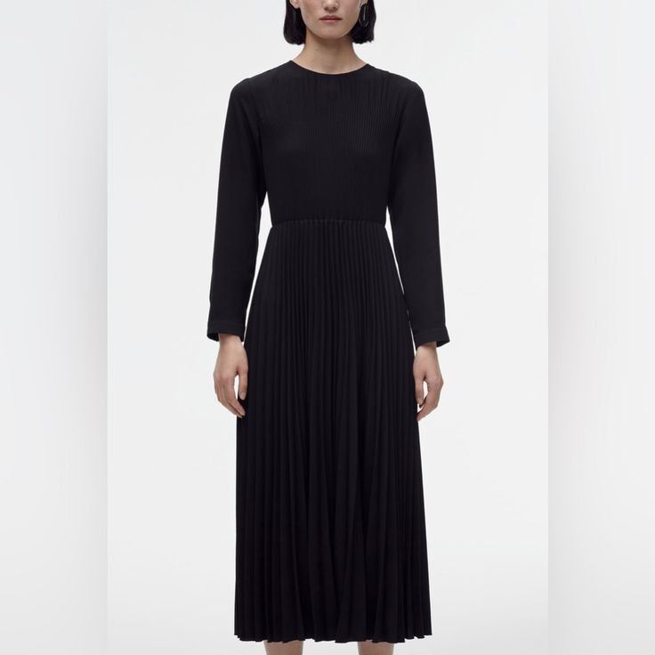 Zara Black Pleated Midi Dress Long Sleeve (Category: Dresses) located in Lupao. Submitted by selahthriftedclothing (Listing ID 1466564151, Image 2). Description: - Color: Solid black - Style: Midi dress with long sleeves and round neckline - Design: Fitted top with a heavily pleated skirt from the waist - Closure: Pullover style with a small back button at the neck - Versatility: Classic, elegant look suitable for work or casual days.